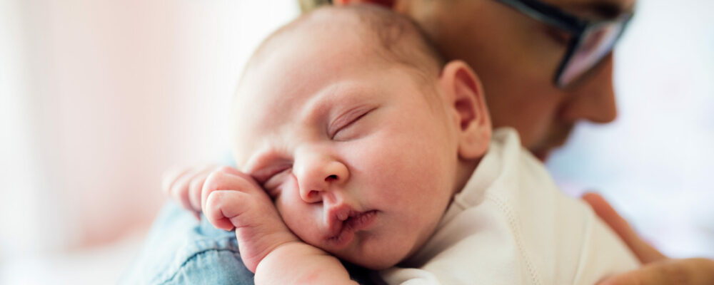 Close,Up,Of,Young,Father,Holding,His,Newborn,Baby,Son